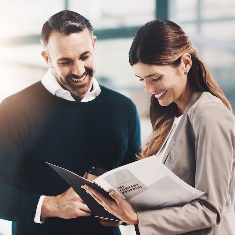 Man, woman and folder for company proposal in office for teamwork, reading or review for project. Business people, partner and attorney with feedback, compliance and happy for results in workplace